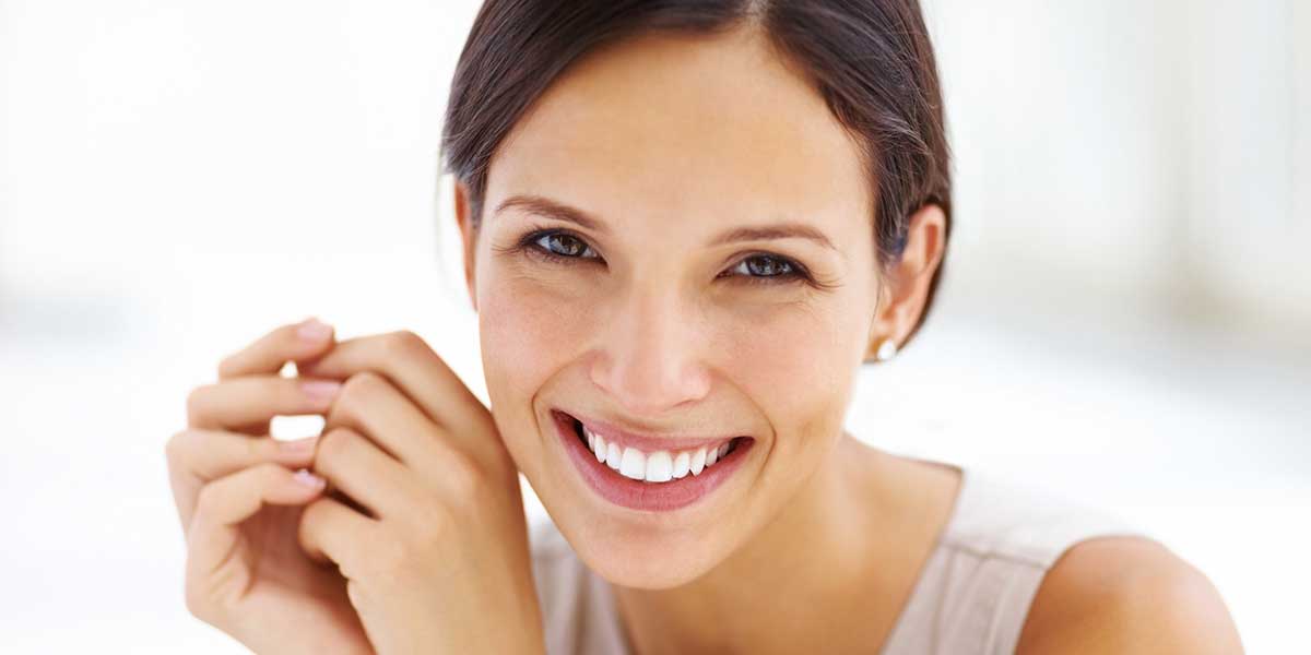 Young adult female smiling after cosmetic dentistry services