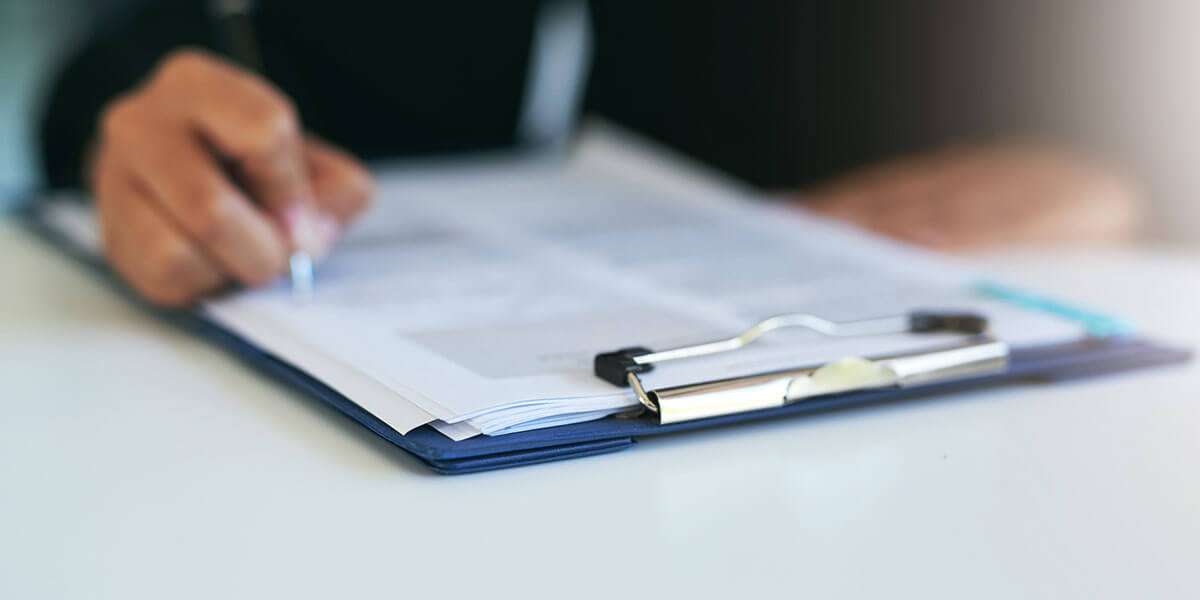 Person signing dental paperwork  