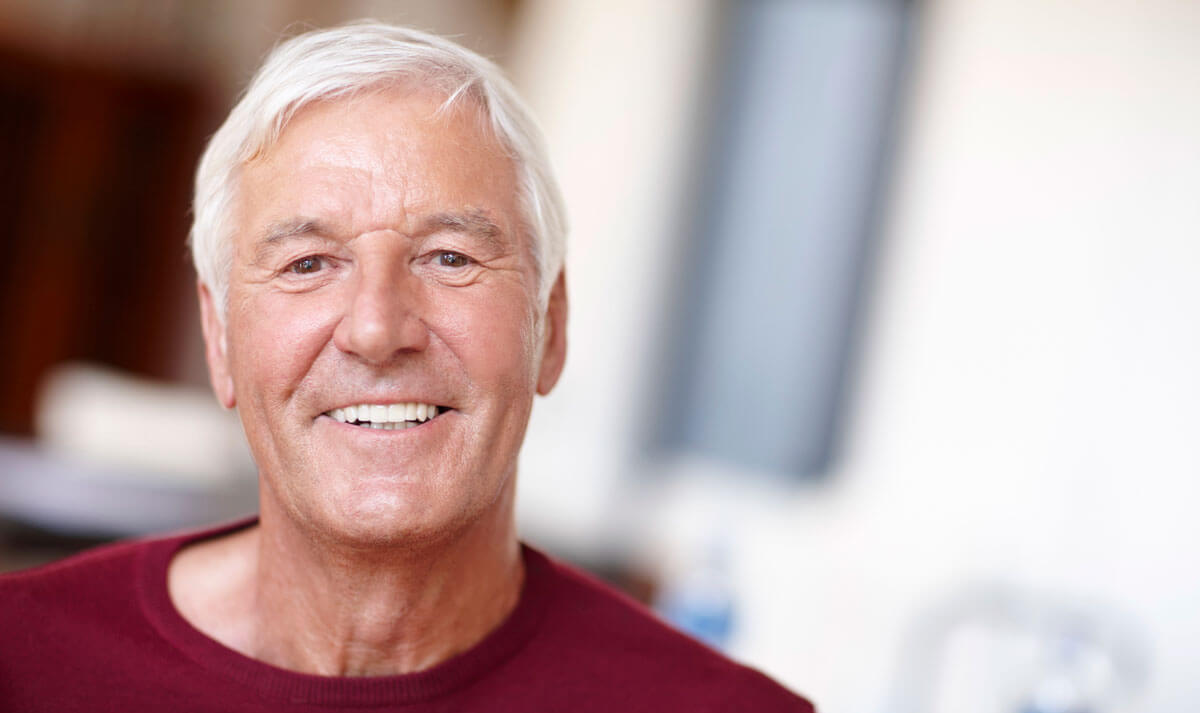 Older man smiling after his dental appointment